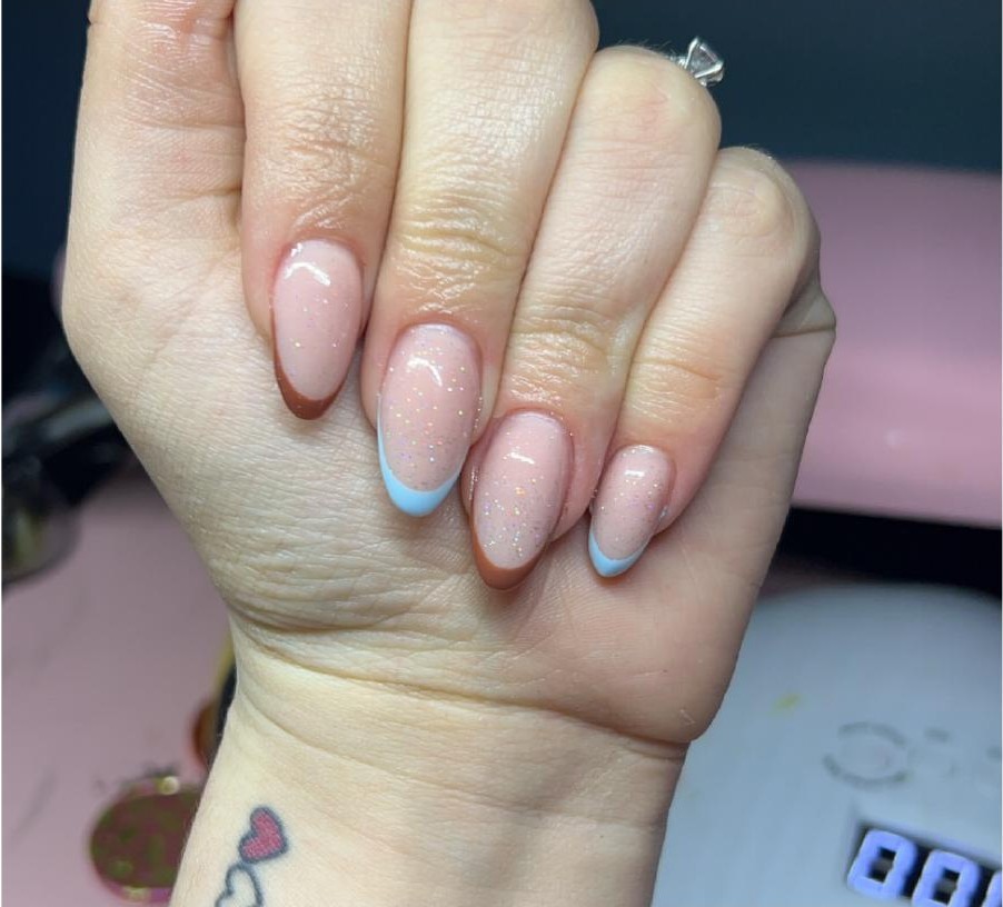 Nude sparkle nails with baby blue French tip accent
