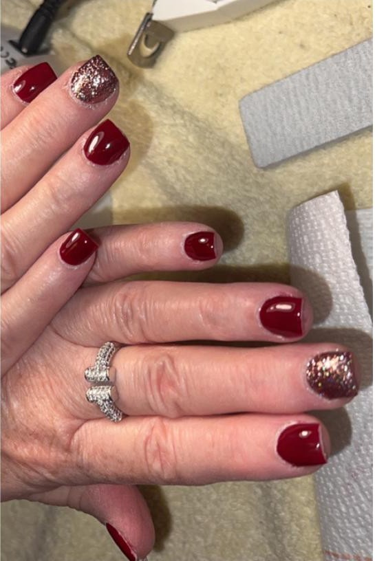 Deep red short nails with rose gold glitter accent nail
