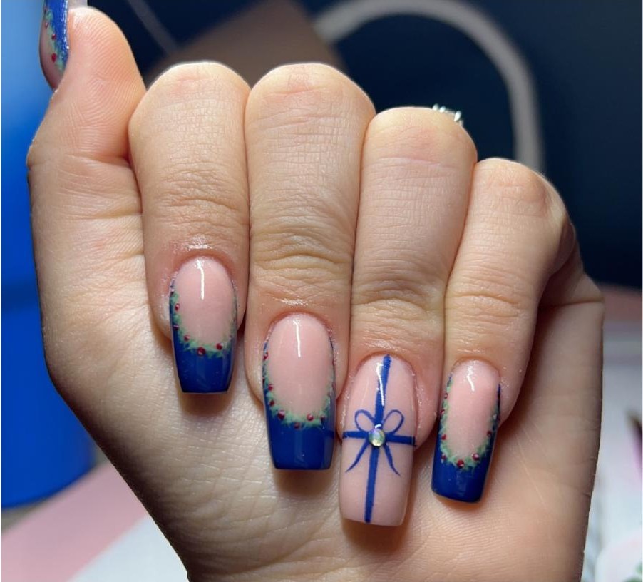 Blue French tip nails with Christmas wreath and bow detail art